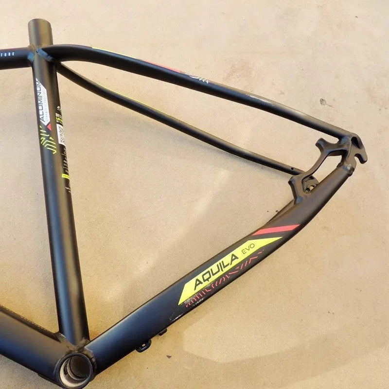Black green 29-inch aluminium mountain bike frame showing internal cable ports and disc brake mount.