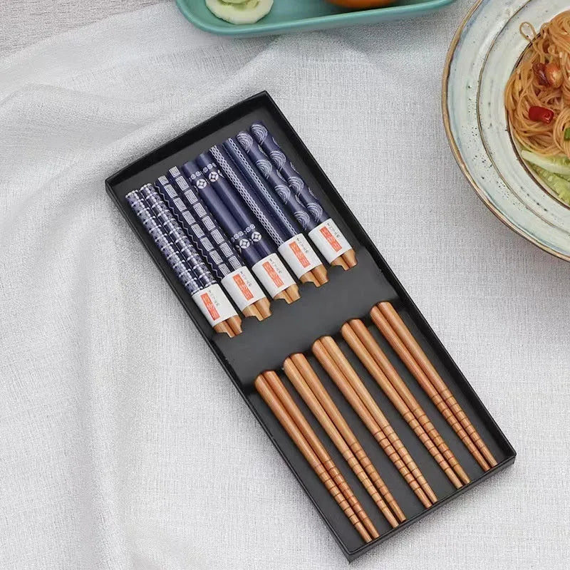 Set of bamboo chopsticks with Japanese lucky cat and elegant blue patterns in gift box or simple packaging.