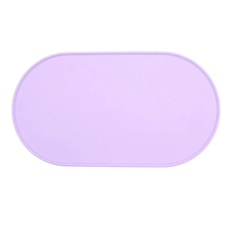 Silicone waterproof placemat for cat food and water bowls in beige colour on a wooden floor.