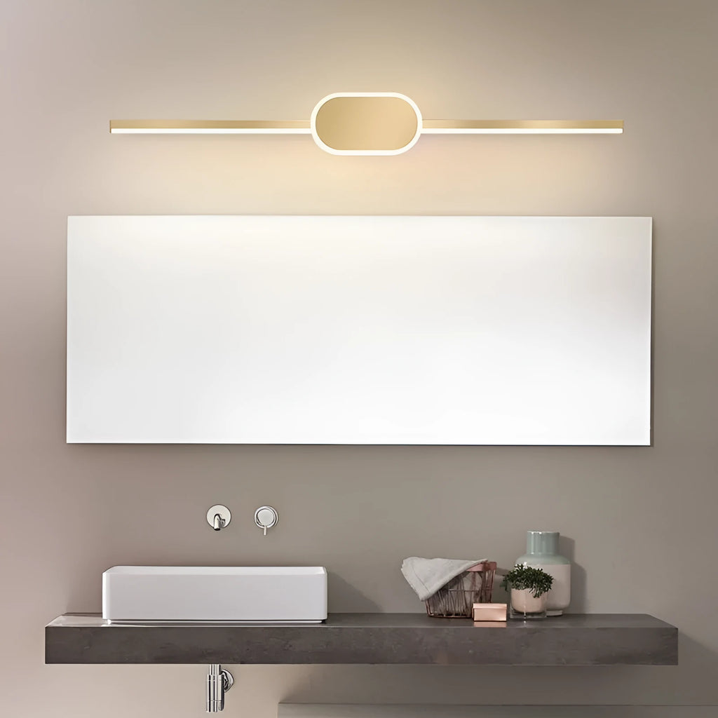 Gold-framed LED mirror cabinet with integrated makeup lights mounted on a bathroom wall.