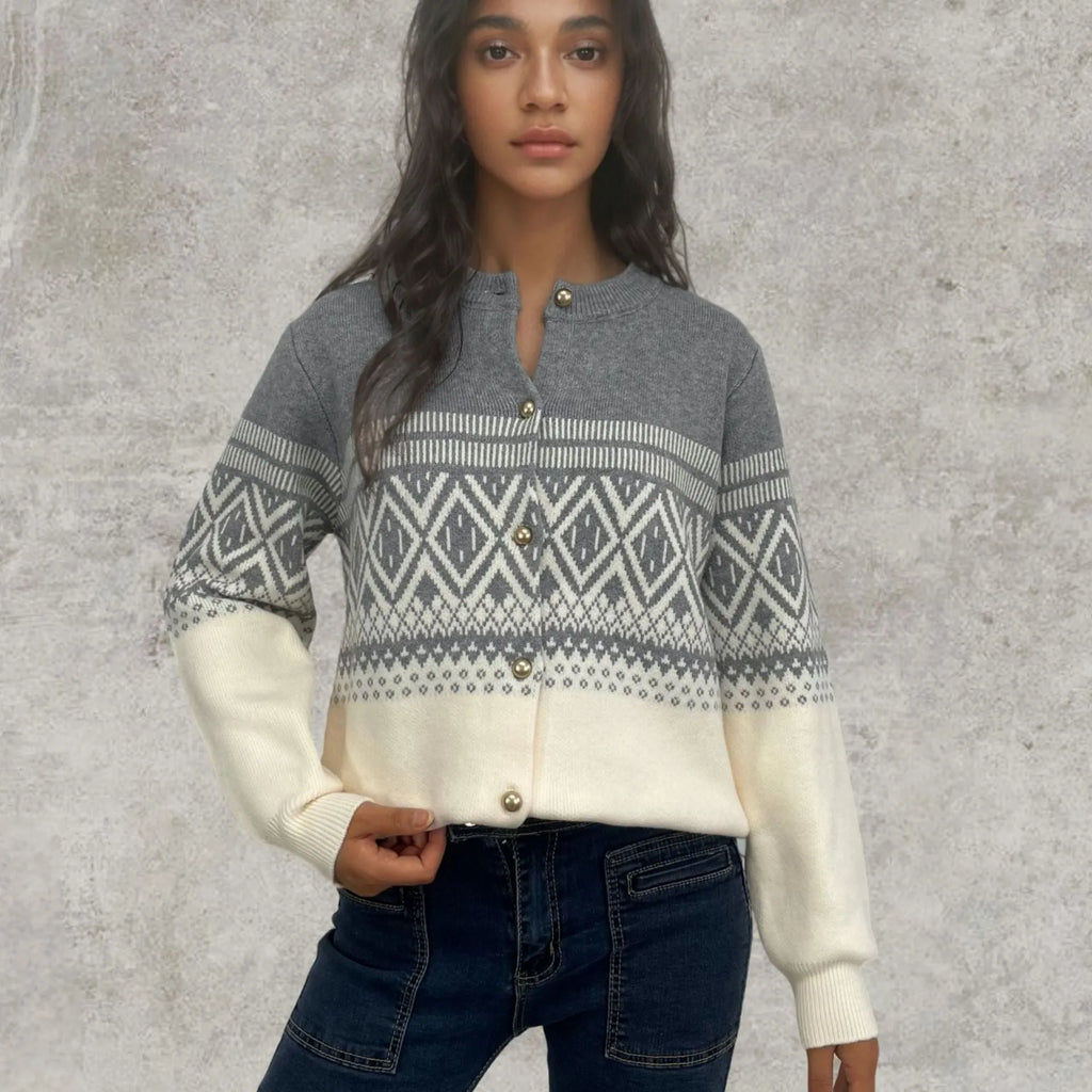 Women's grey alpaca wool cardigan with a red and white diamond knit pattern and long sleeves.