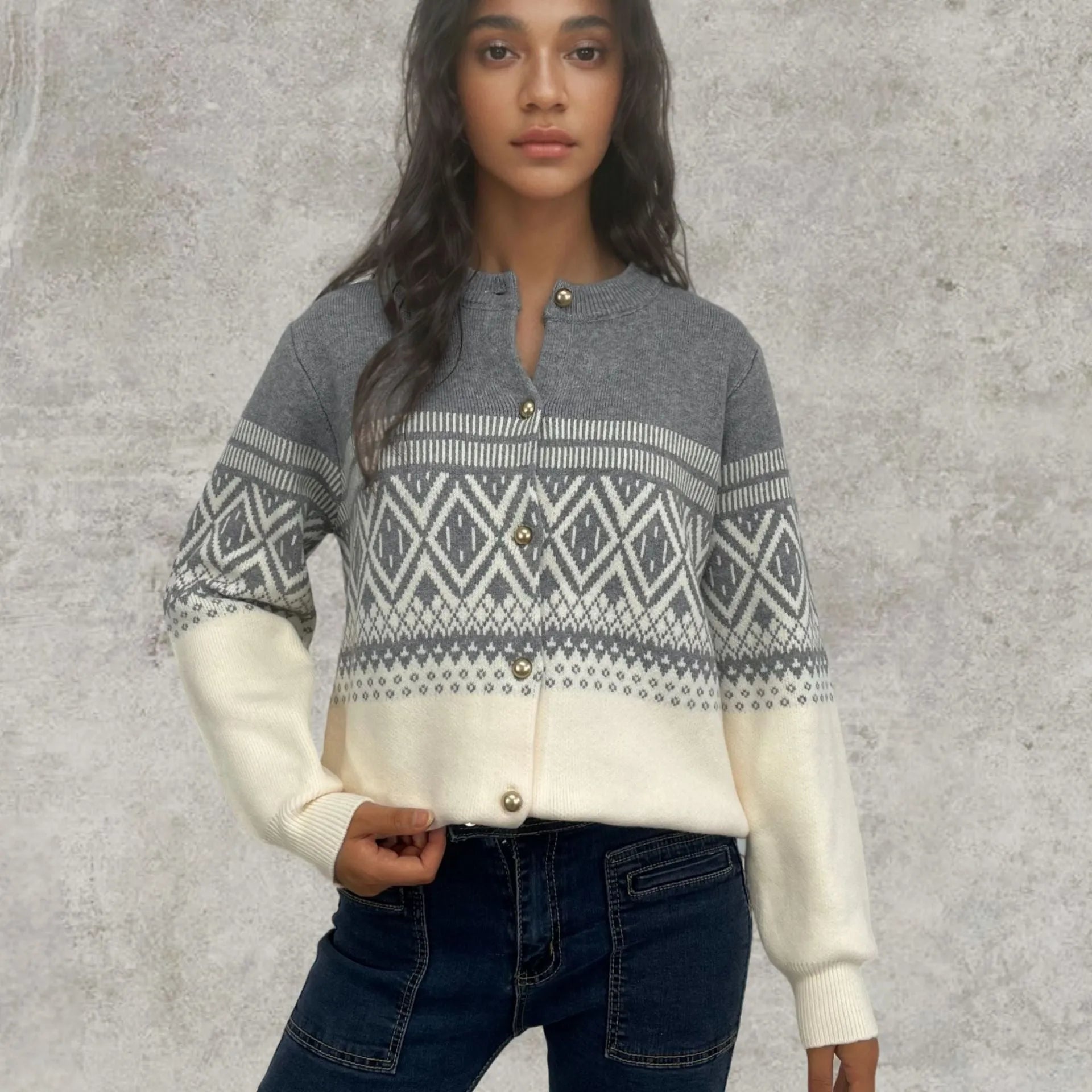 Women's grey alpaca wool cardigan with a red and white diamond knit pattern and long sleeves.