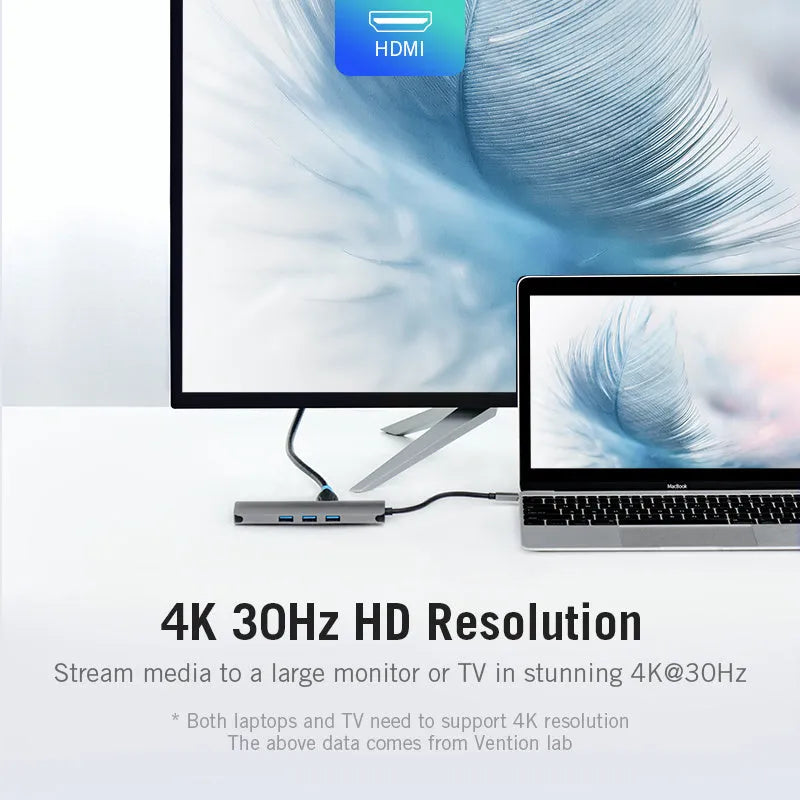 Deep grey USB-C to 8-in-1 hub with HDMI, USB ports, Ethernet, card slots, and a short cable on a desk.