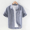 Men's light grey linen short sleeve shirt with a square collar, shown unbuttoned in a cardigan style.