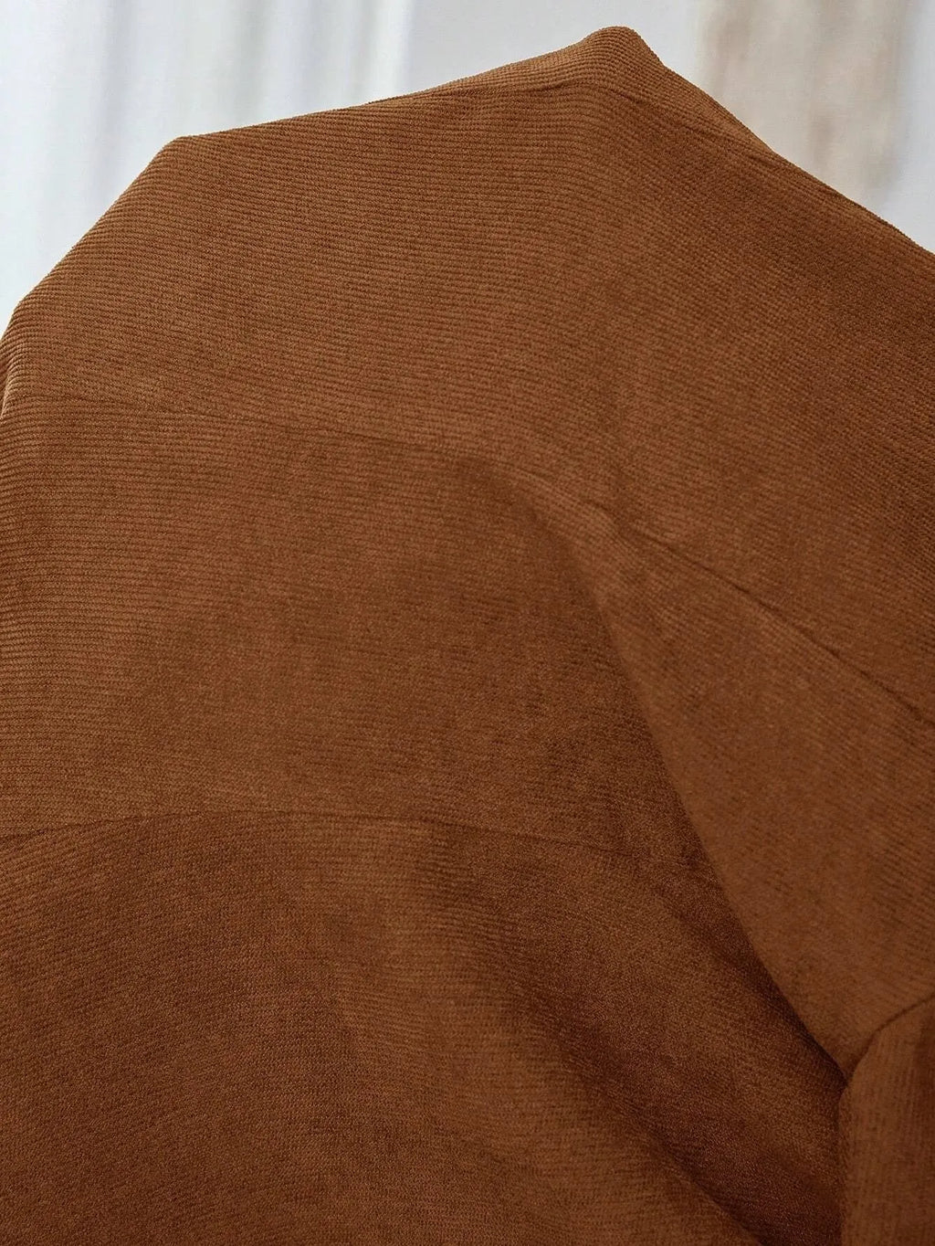 Brown men's single-breasted lapel blazer jacket on a hanger