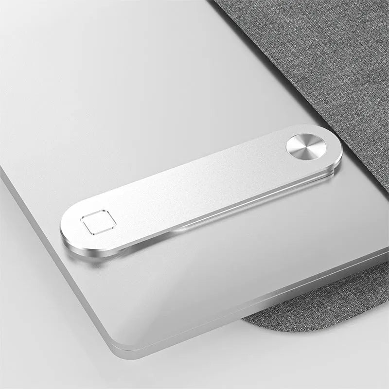 Black aluminium laptop phone holder with magnetic mount attached to a monitor showing a smartphone in place
