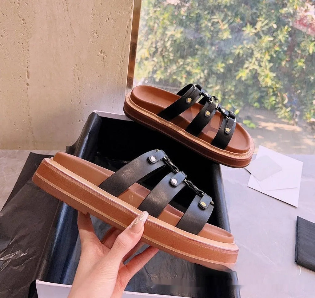 Women's black Roman-style sandal slippers made of glossy patent leather and soft sheepskin.