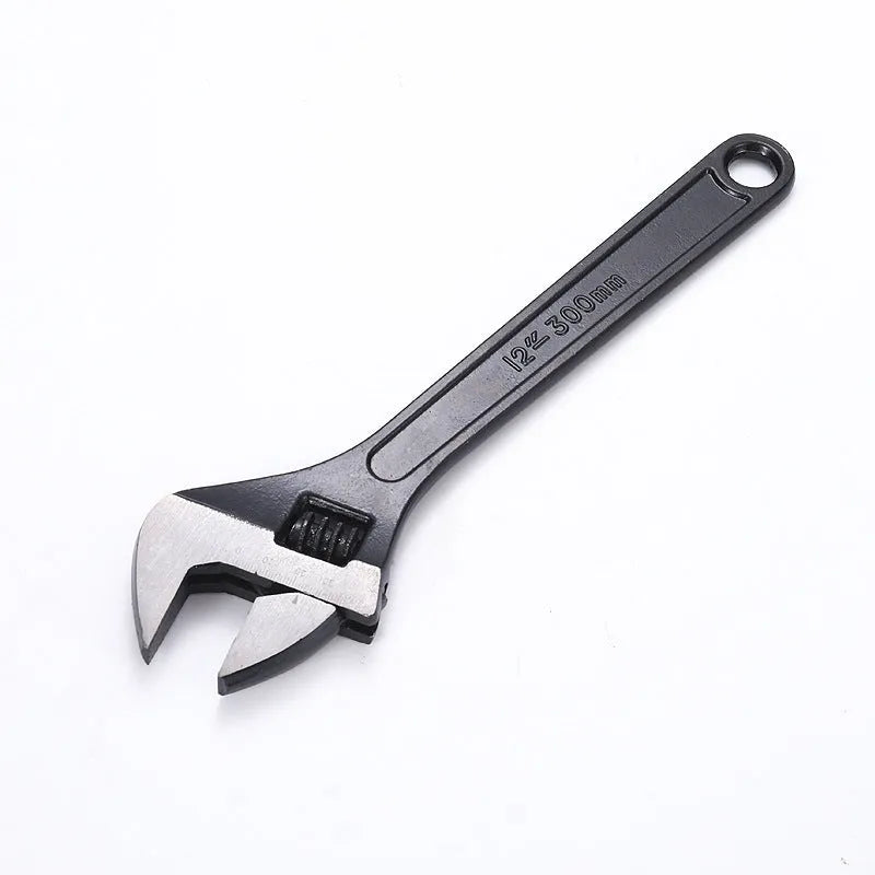 Stainless steel adjustable open-end wrench on a workbench