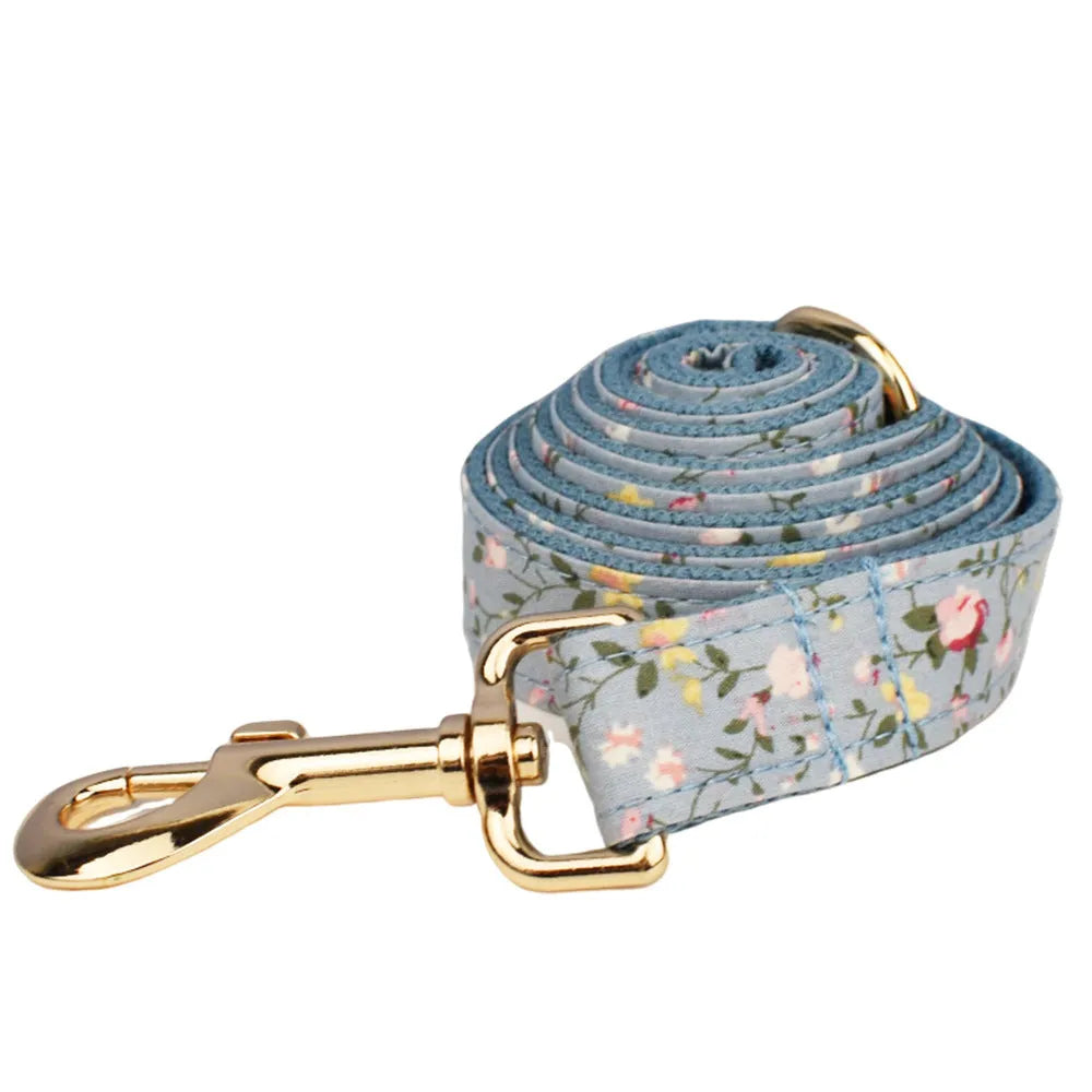 Blue floral patterned fabric bow attached to a decorative dog collar for pets
