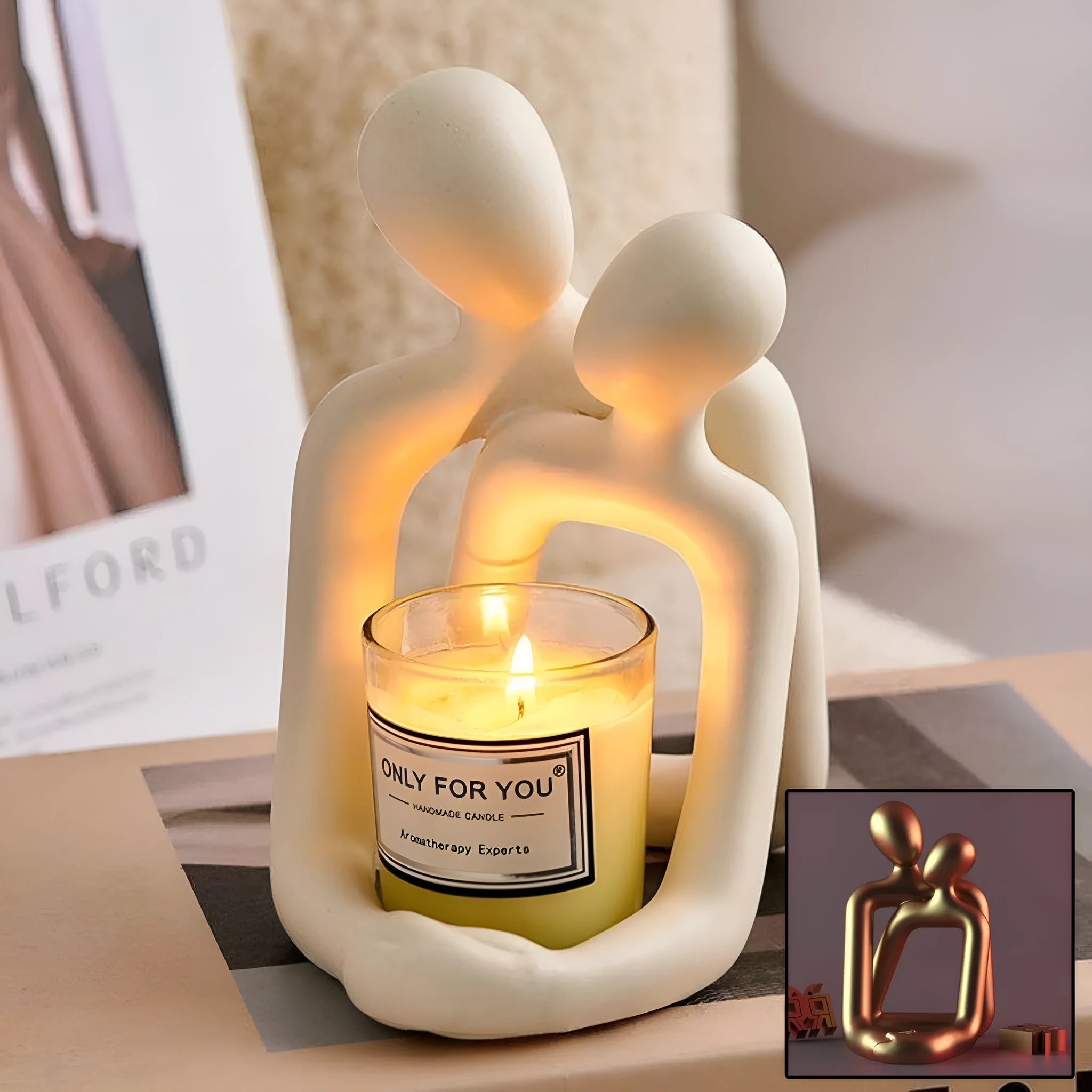 Modern loving couple resin statue in gold or milky white finish on a wooden desk.