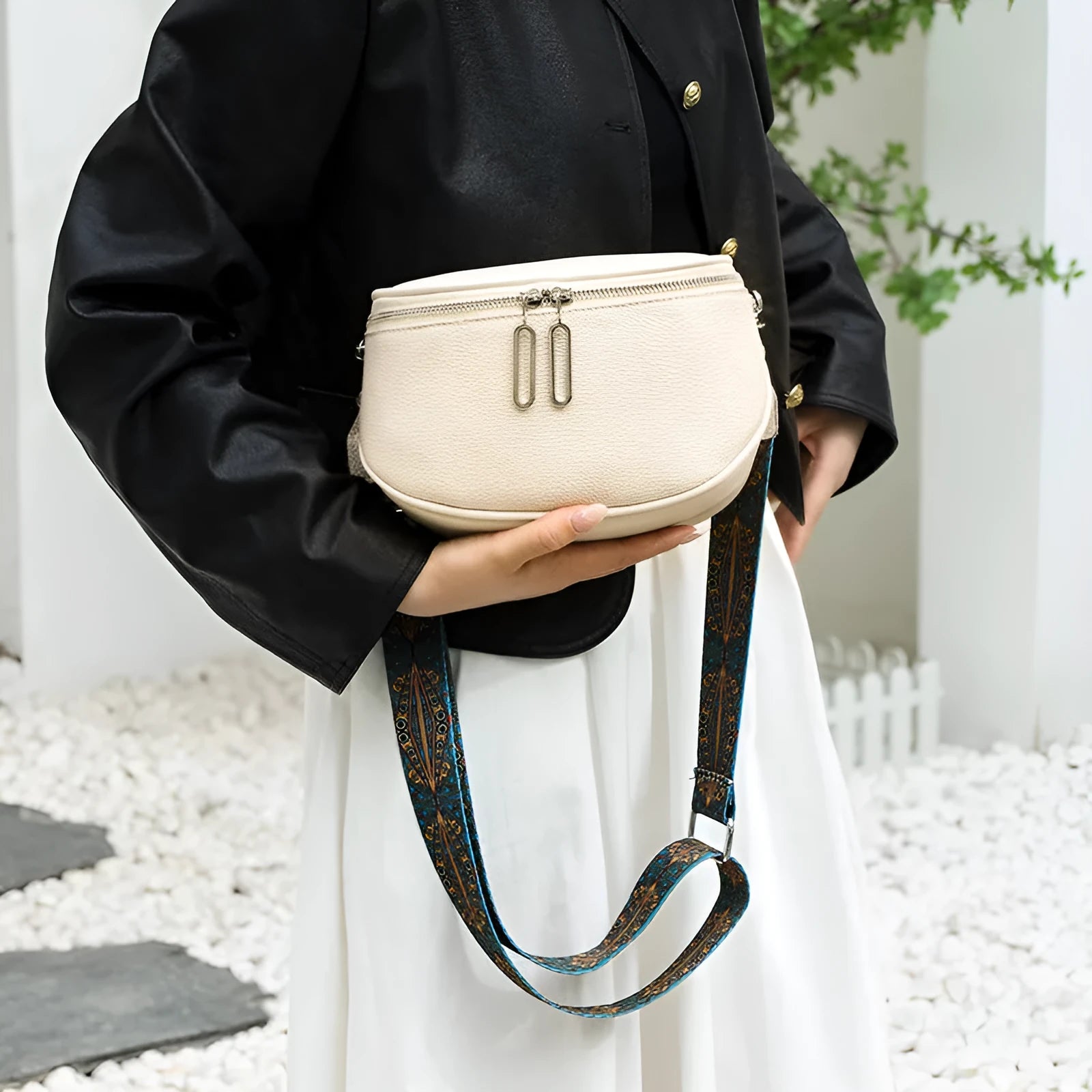 Women's soft black leather saddle-shaped crossbody messenger bag with a zip pocket.