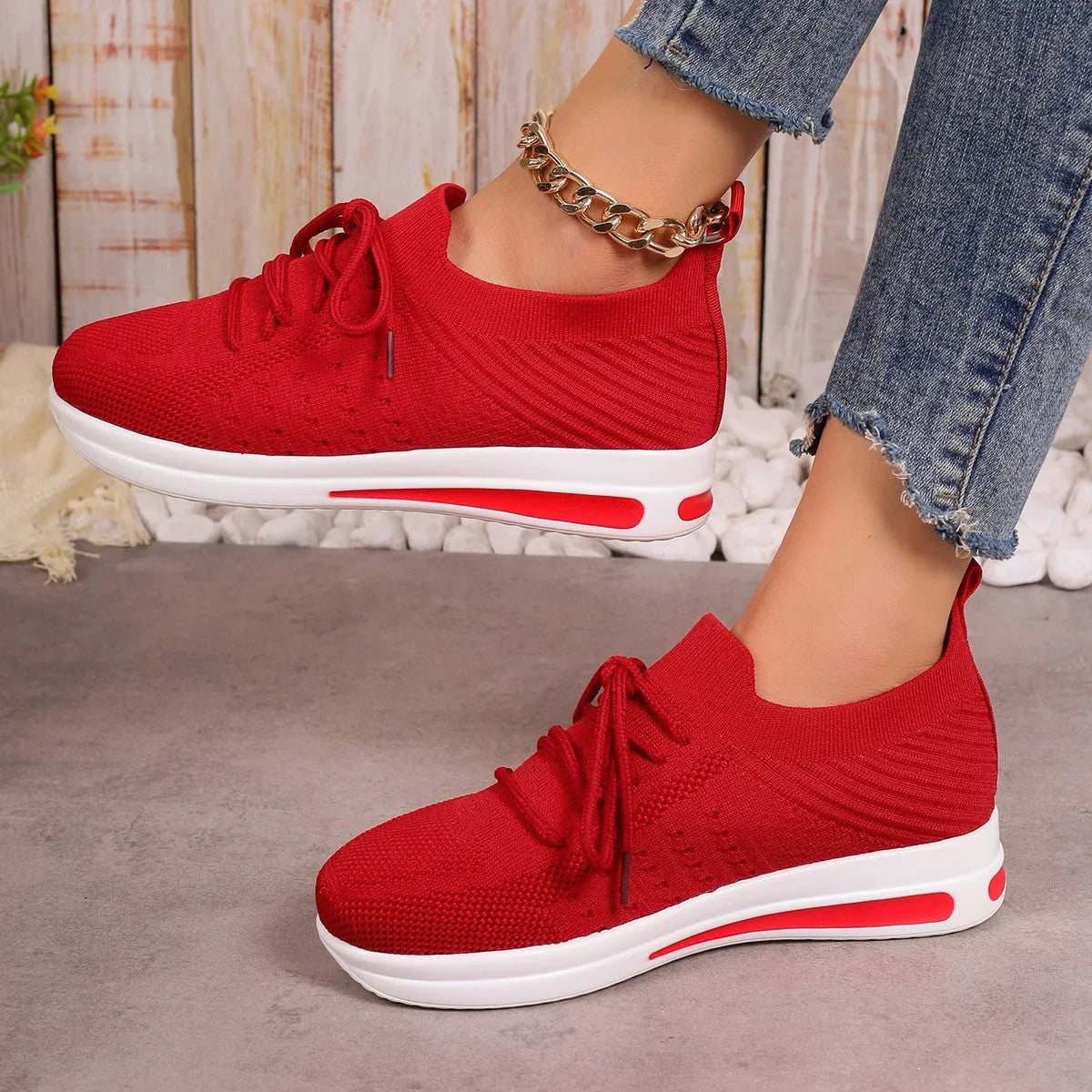 Women's fly-knit casual sneakers in solid black, blue, or red with a lace-up front and low-top design.