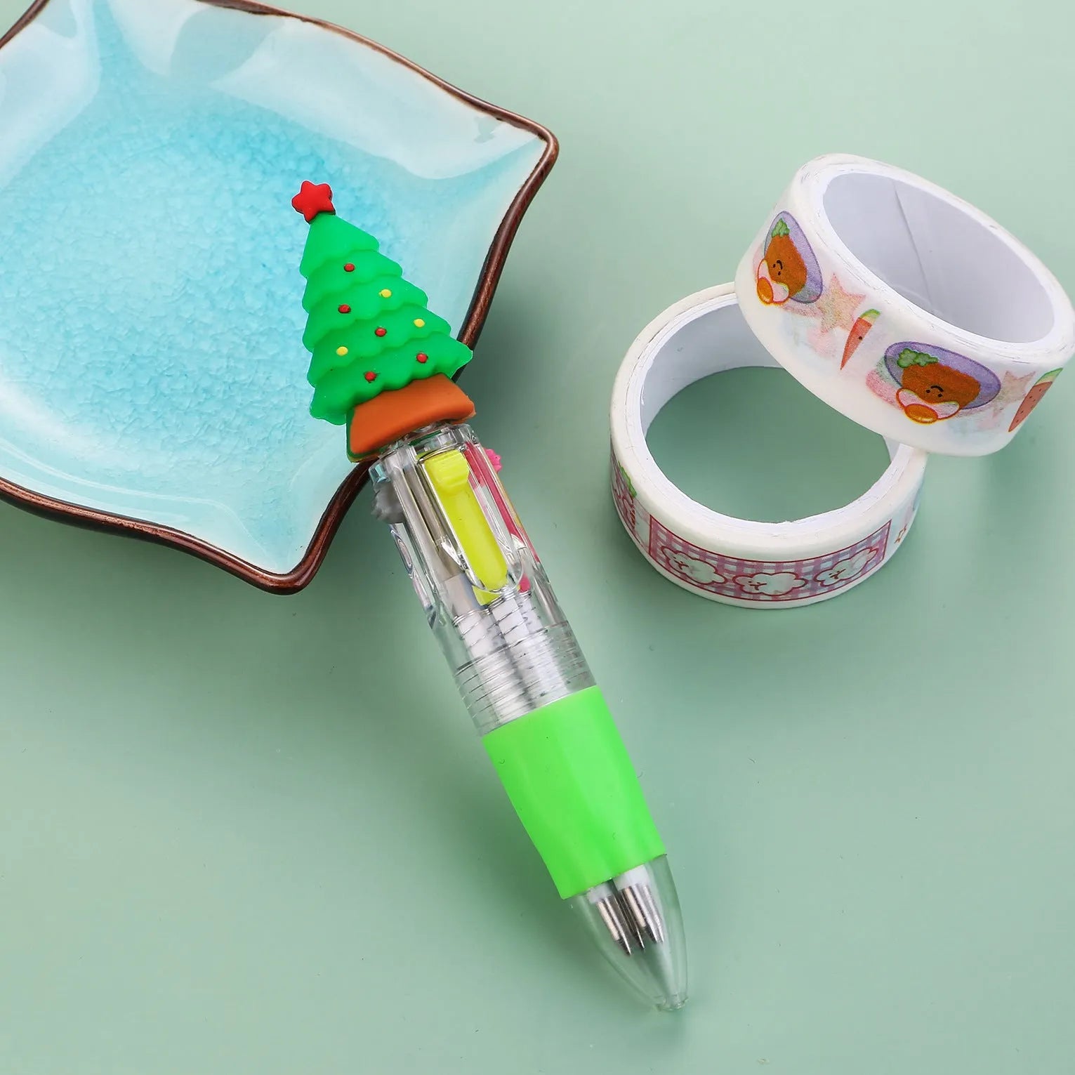 Christmas mini four-colour press-action ballpoint pen with festive designs measuring 11 cm.