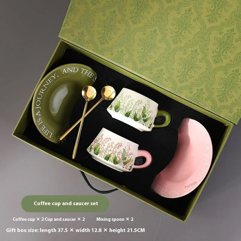 Ceramic coffee cup and saucer set for couples with stirring spoons in two pattern choices.