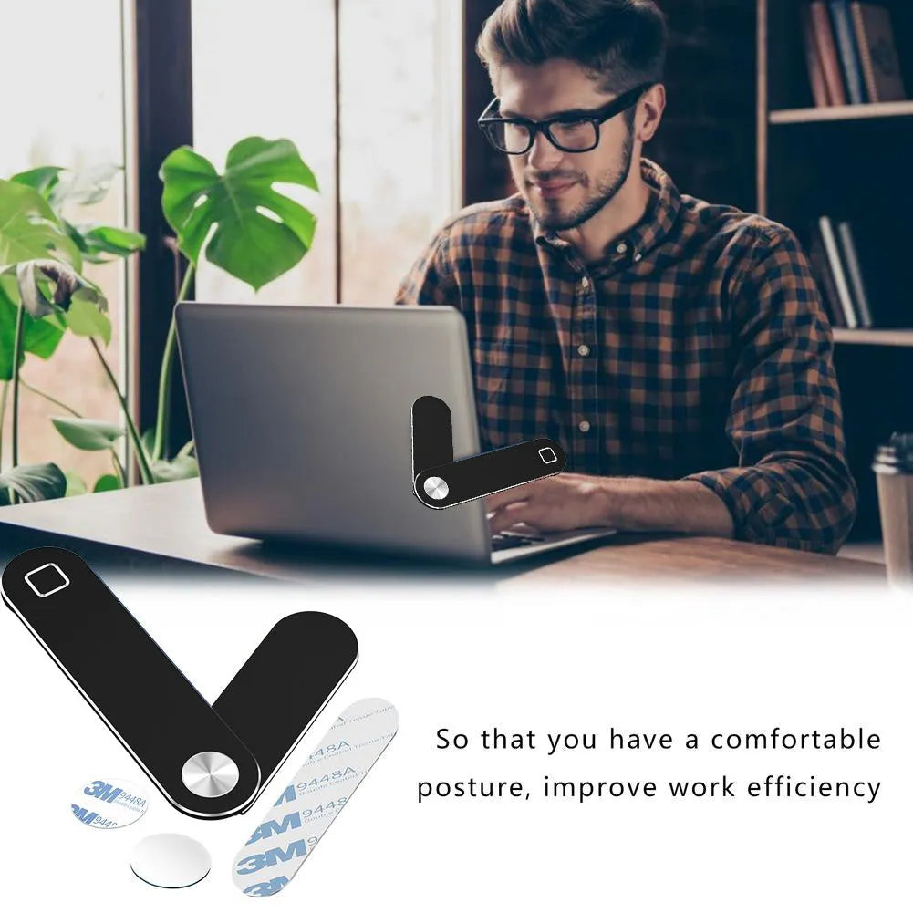 Black aluminium laptop phone holder with magnetic mount attached to a monitor showing a smartphone in place