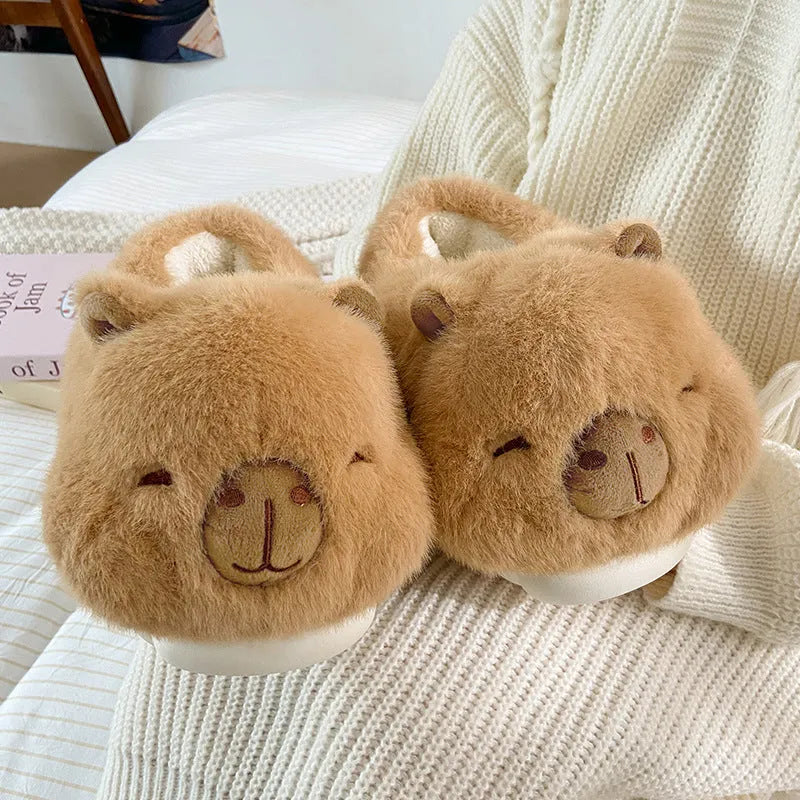 Light brown women's winter slippers with cotton plush upper and cartoon pattern.