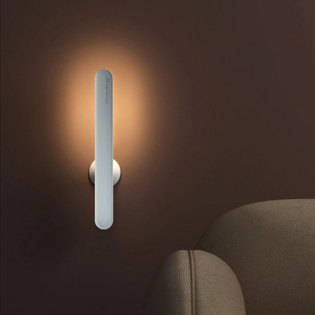 Geometric design table lamp with magnetic base on desk next to USB cable