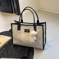 Women's printed canvas tote bag with diamond pattern, sandwich pocket, and shoulder strap