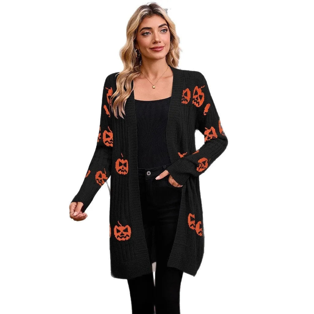 Women's black Halloween cardigan with orange pumpkin head jacquard knit pattern, shown open.