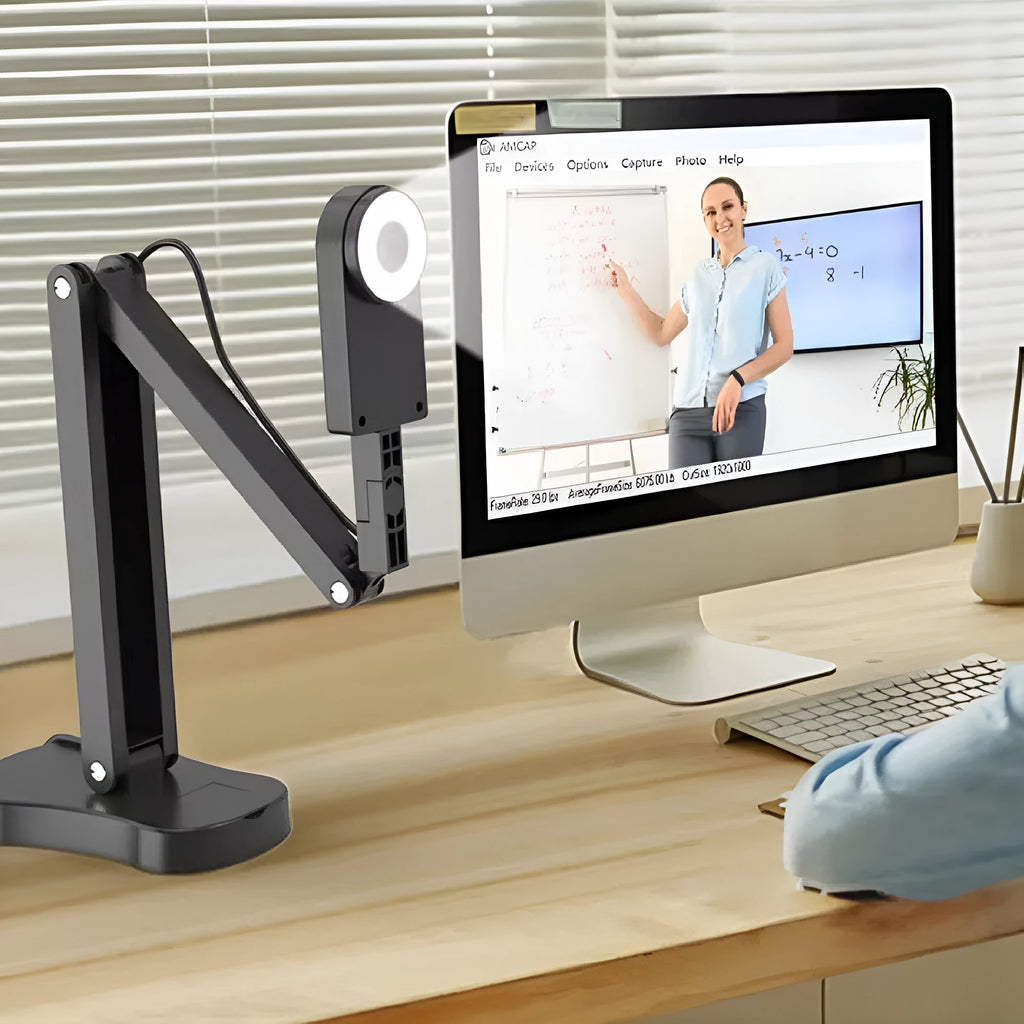 USB computer webcam with microphone for video calls and streaming on a desk.
