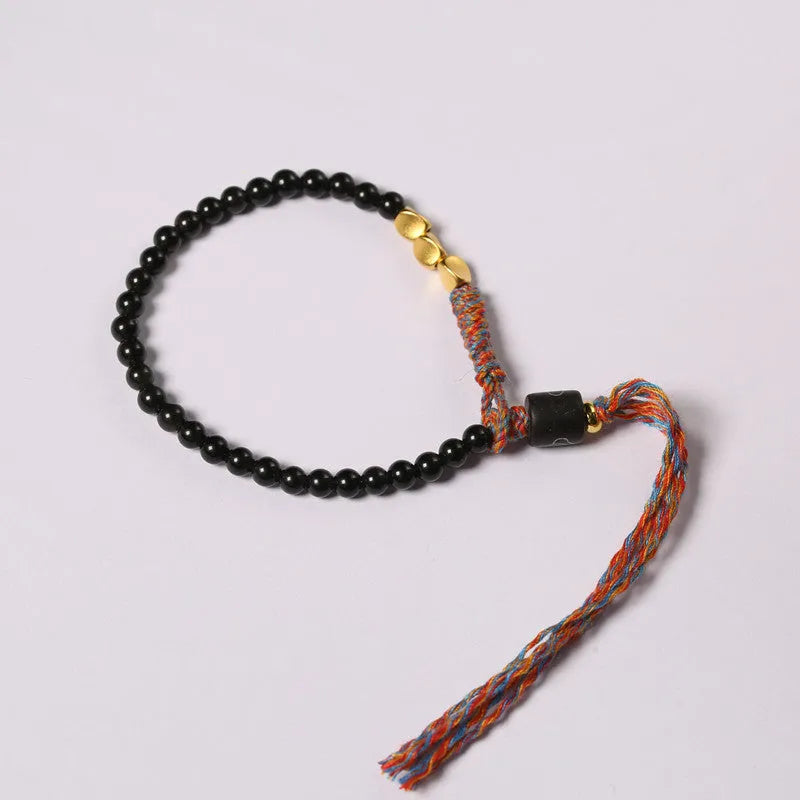 Hand-woven obsidian bead bracelet strap on a wrist, showing its 4mm width and dark colour.