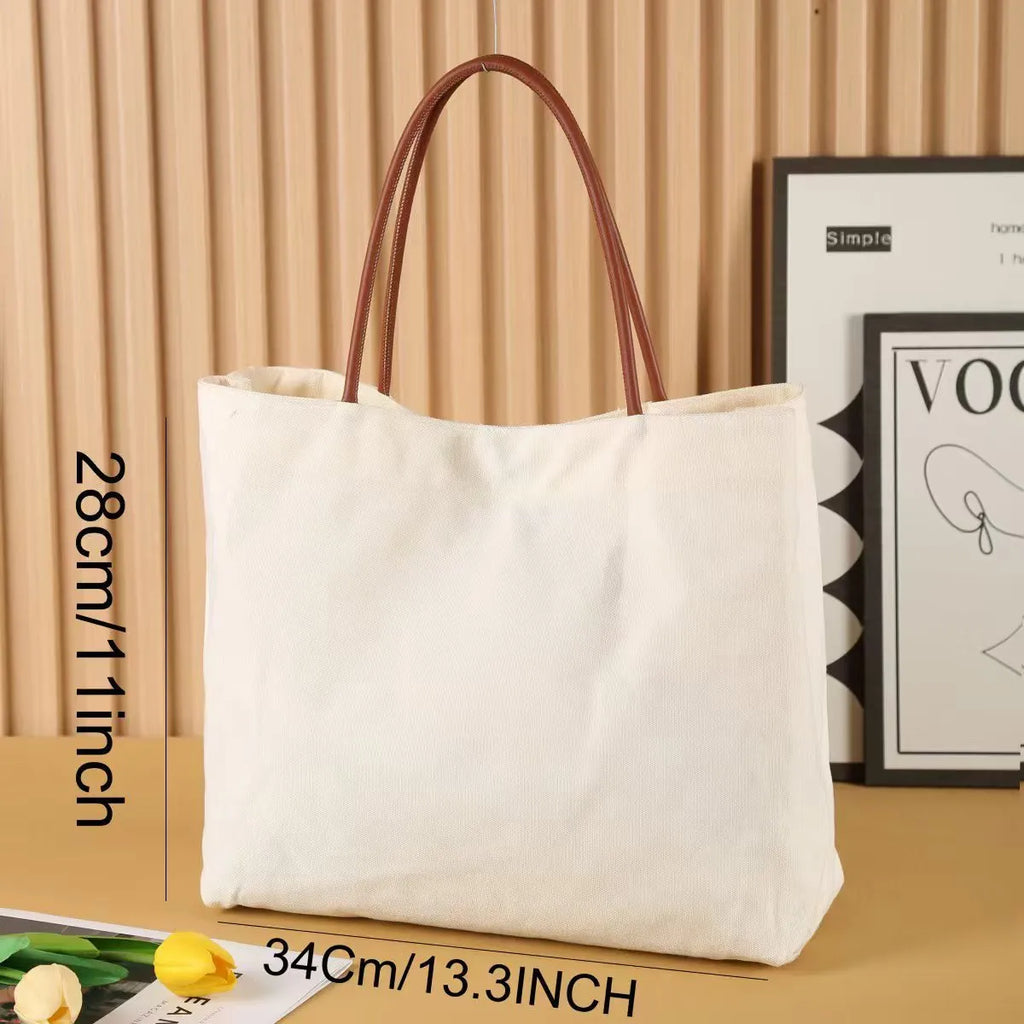 Heavy-duty cotton canvas tote bag with internal pockets, shown in beige white colour.