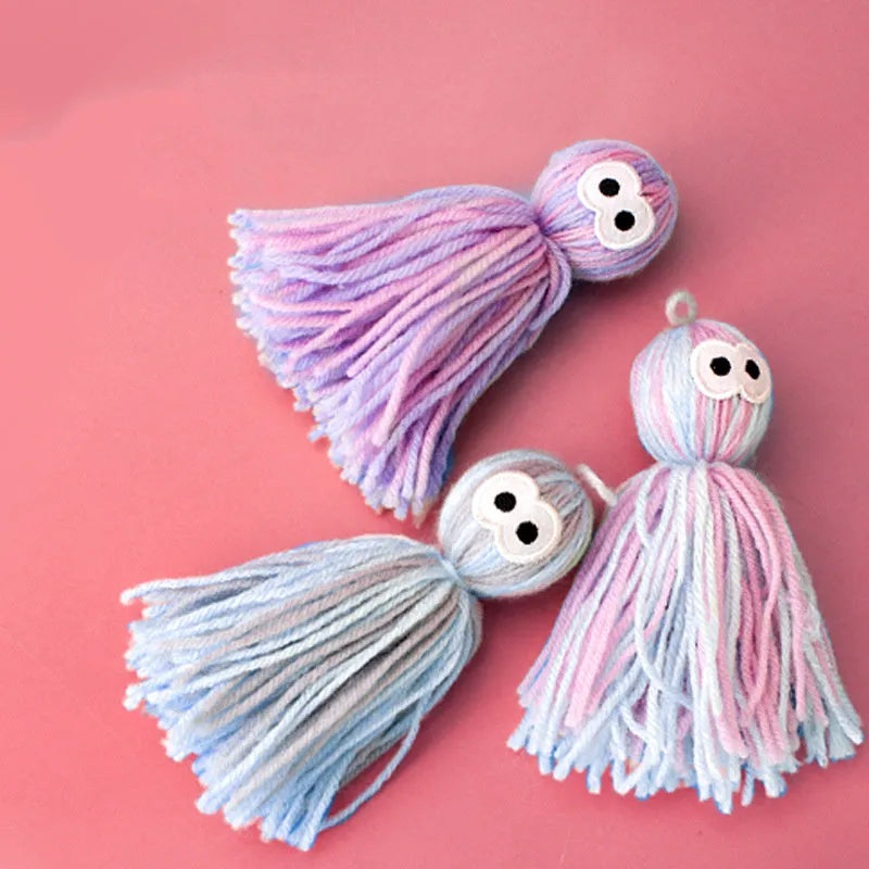 Wool ball cat toy with hanging loop in blue grey, pink and blue, and pink purple colour options