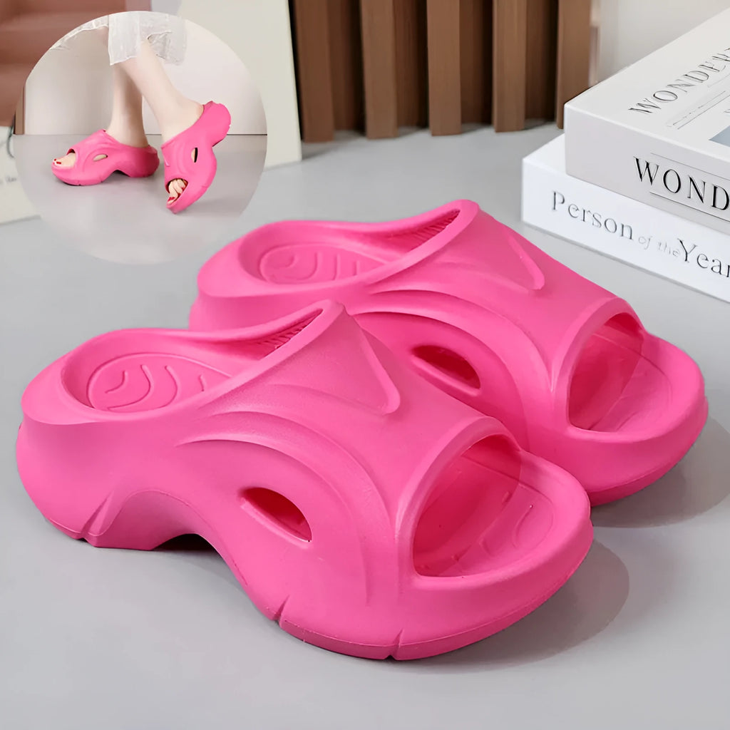 Women's white thick-soled EVA beach slippers with round toe, shown on a sandy background.