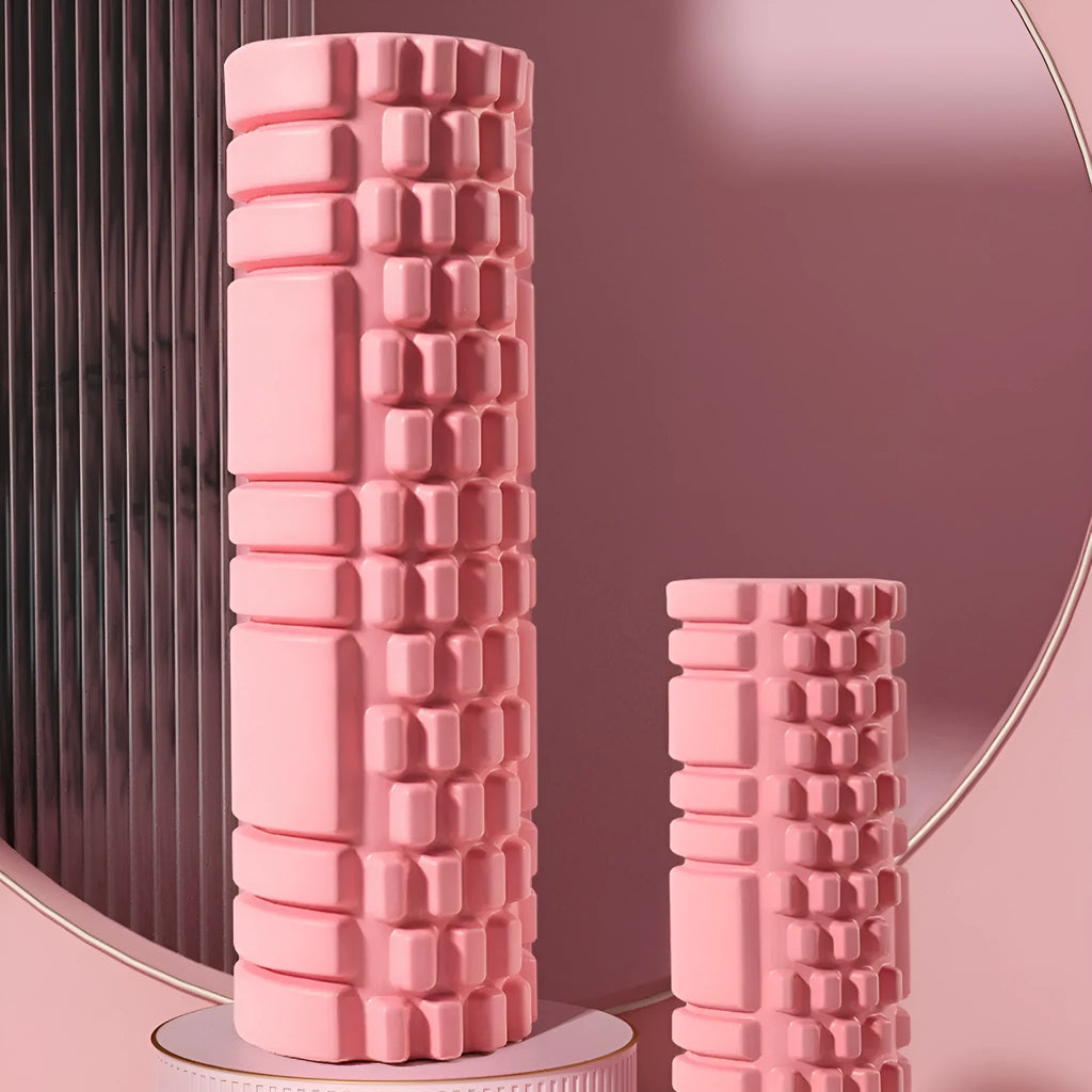 EVA foam fitness roller in black on a wooden floor, showing cylindrical shape and textured surface.