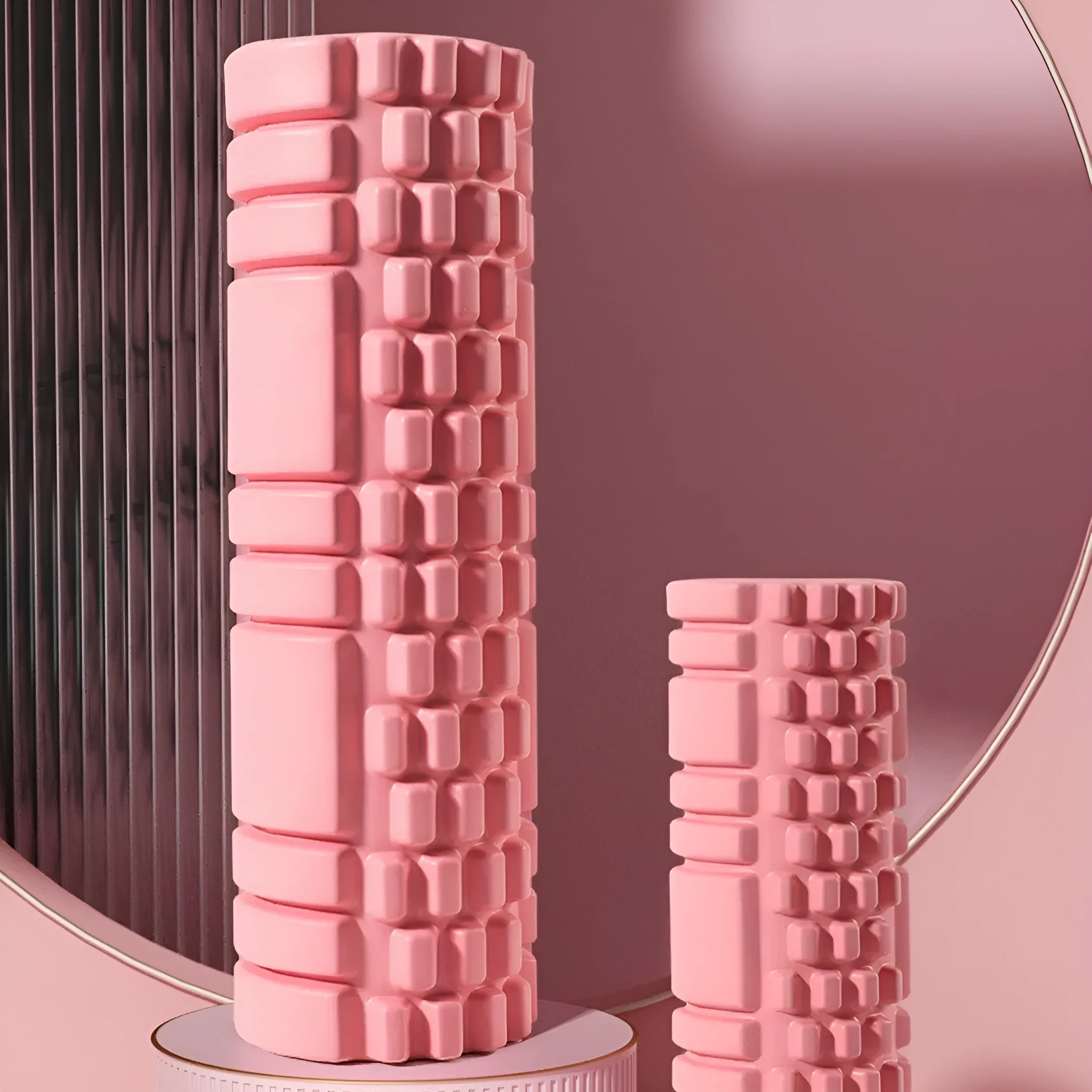 EVA foam fitness roller in black on a wooden floor, showing cylindrical shape and textured surface.