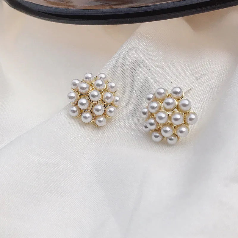 Women's gold electroplated alloy drop earrings with pineapple design and starfish pearl, featuring inlaid stones.