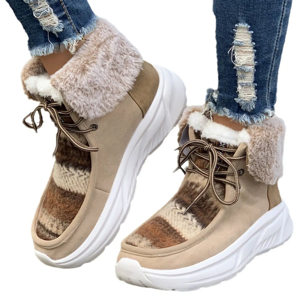Women's beige lace-up snow boots with suede upper and fur lining on a white background.