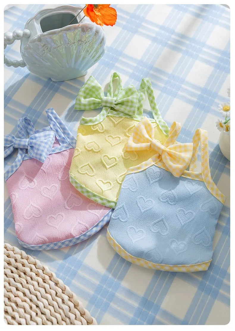 Small dog wearing elastic vest with heart texture and bow suspenders in Bondi Blue colour
