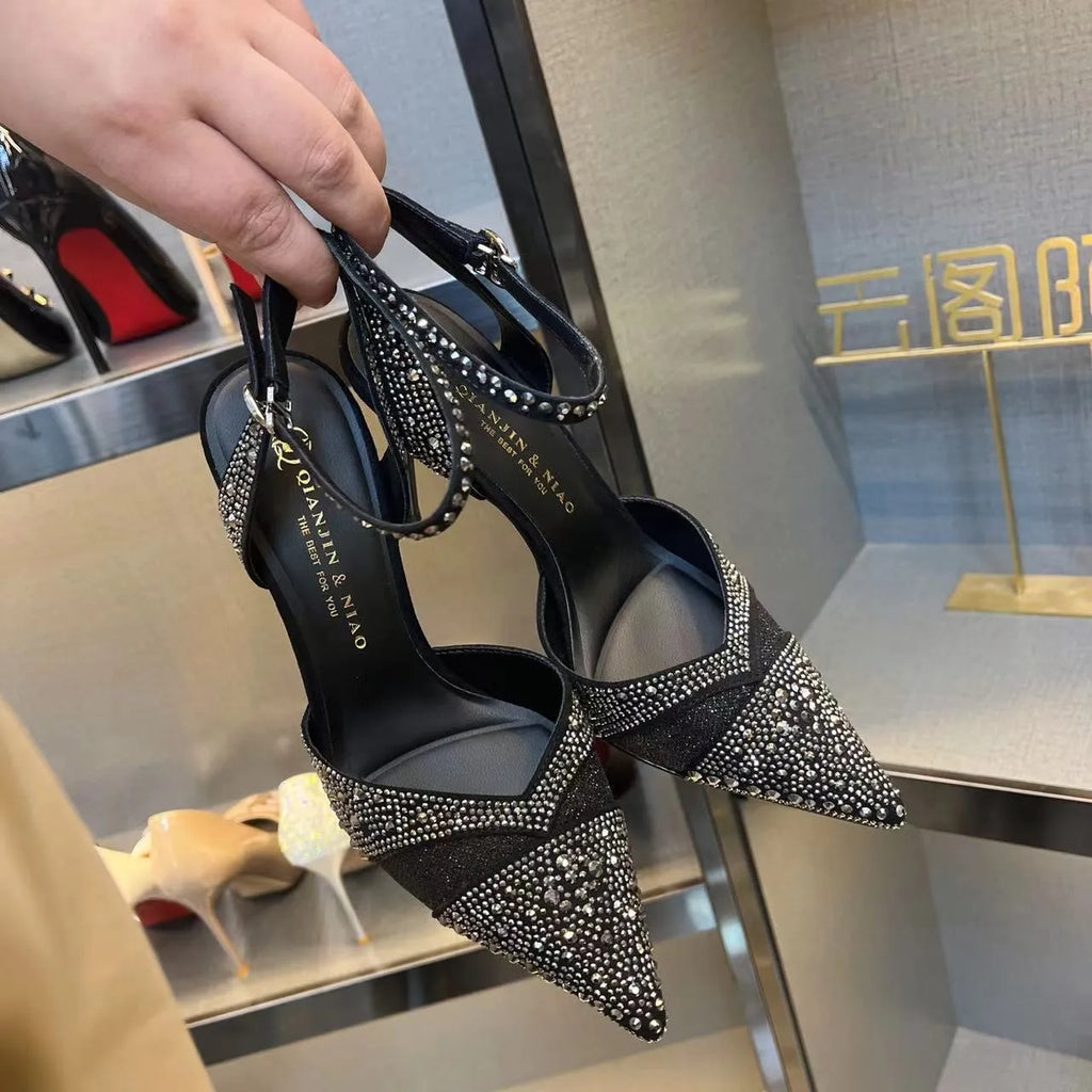 Women's silver and black hollow high heels with red sole and pointed stiletto heel