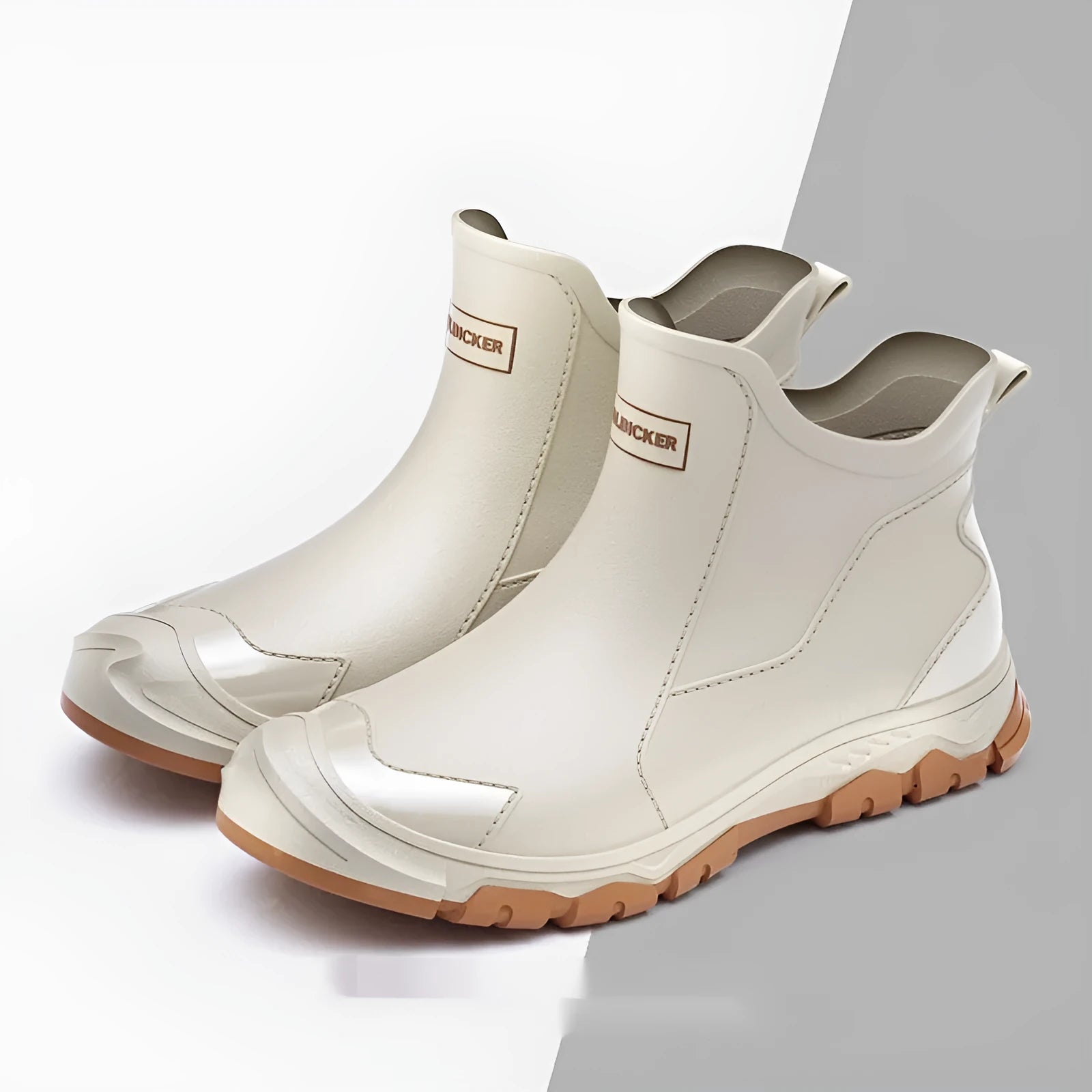 Short black PVC wading boots with a round toe and flat heel on a white background.