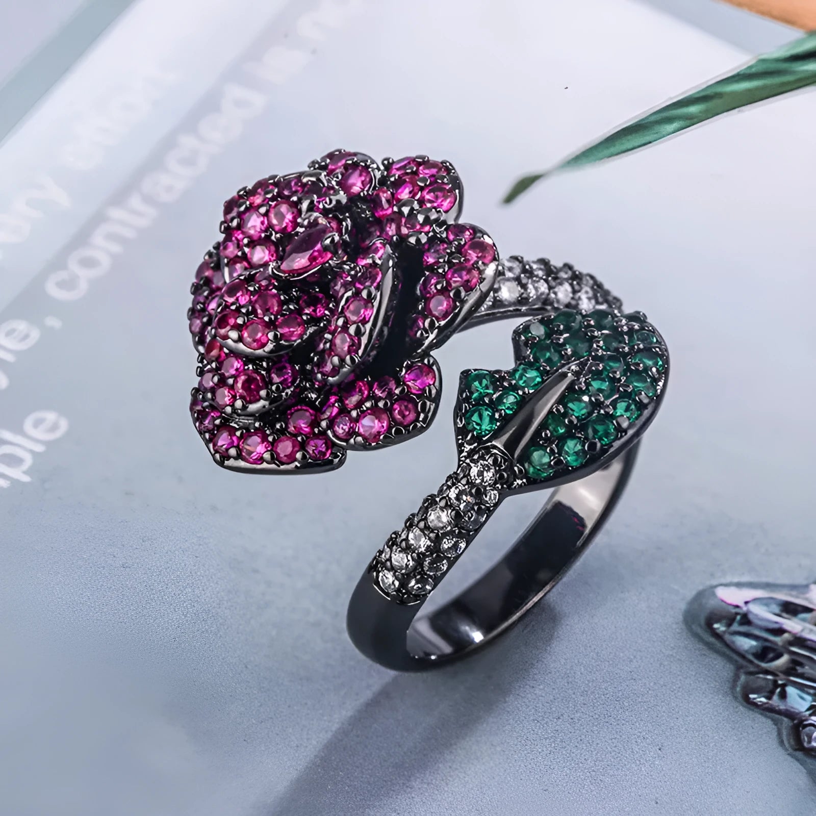 Black gold geometric flower ring with simulated red corundum centrepiece on copper base