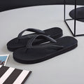 Casual rubber flip-flops with fish label on strap, showing non-slip sole.