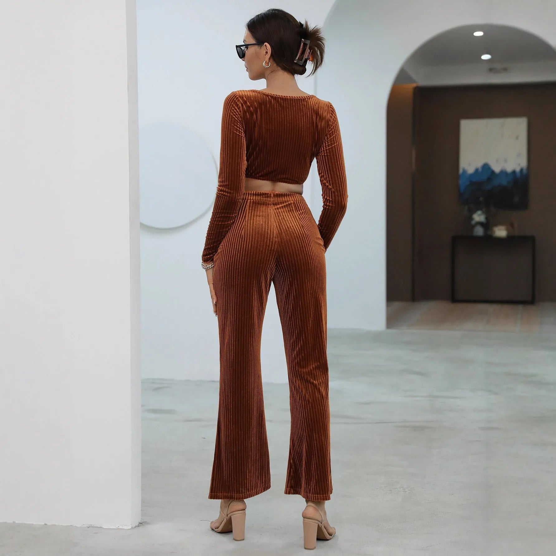 Caramel coloured long sleeve sweater and trouser casual set laid flat.
