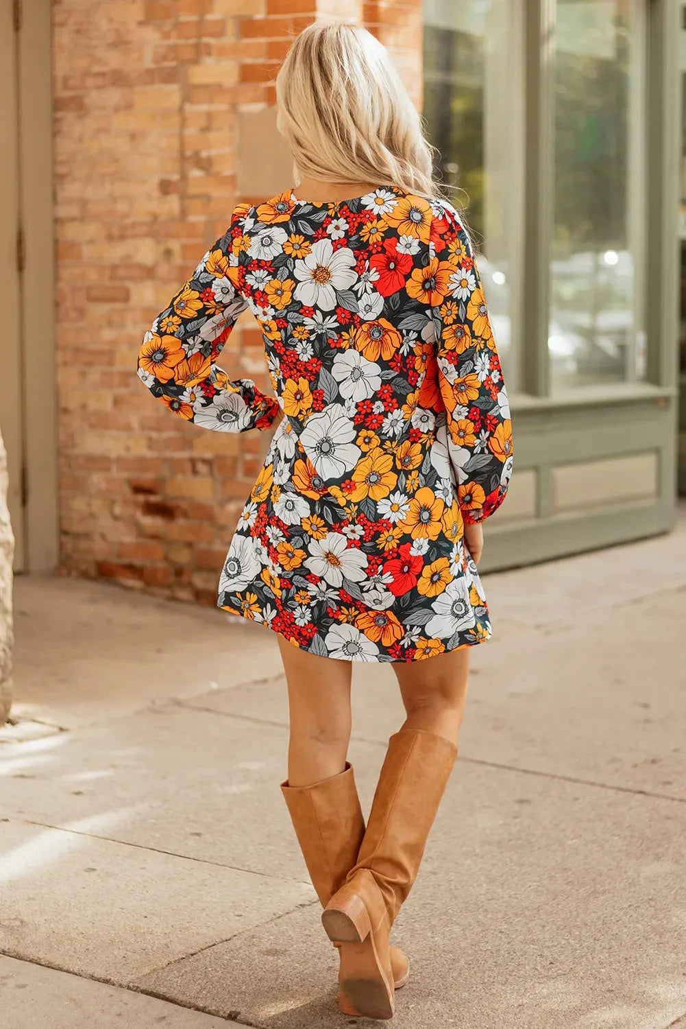 Orange floral print women's mini dress with striped lace detailing, V-neck, and long sleeves.