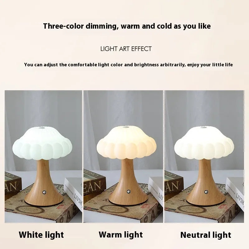 Mushroom-shaped touch control night light in cream colour on a wooden table.
