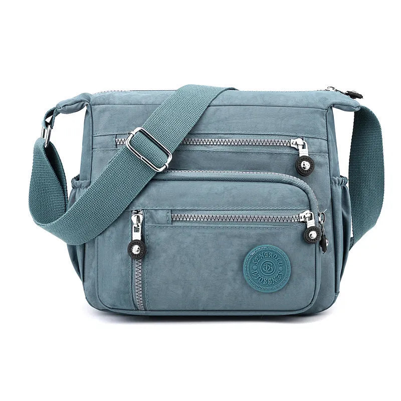 Grey nylon shoulder messenger bag with single strap and square vertical design