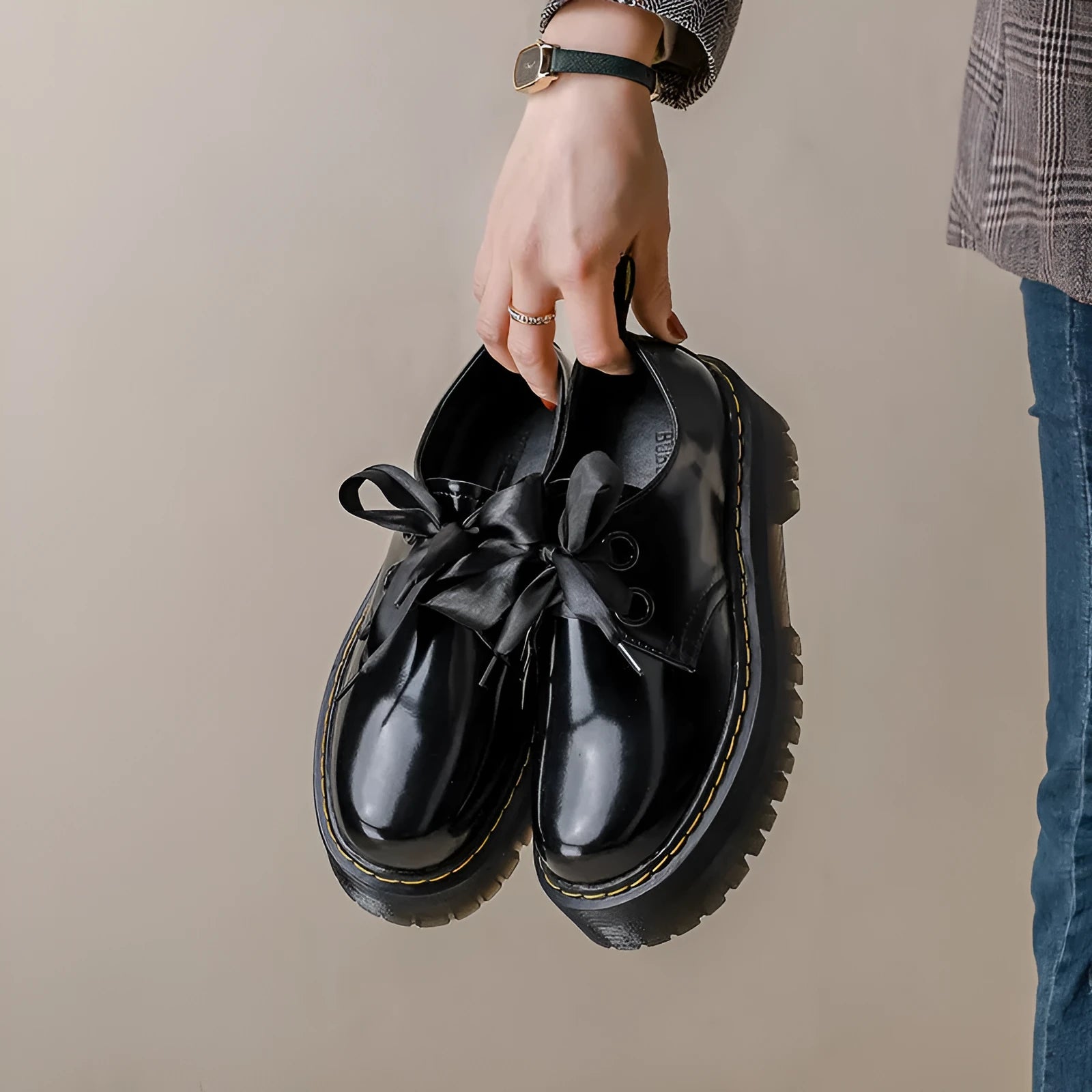Women's thick soled leather shoes with ribbon cross straps and lace-up closure in black colour