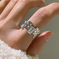 Geometric cross zircon ring with silver plating and open gemstone setting showing three-dimensional decoration
