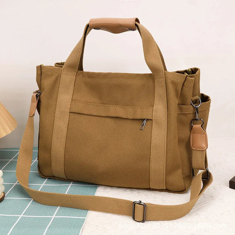 Women's large capacity canvas crossbody tote bag with organiser pockets in black colour
