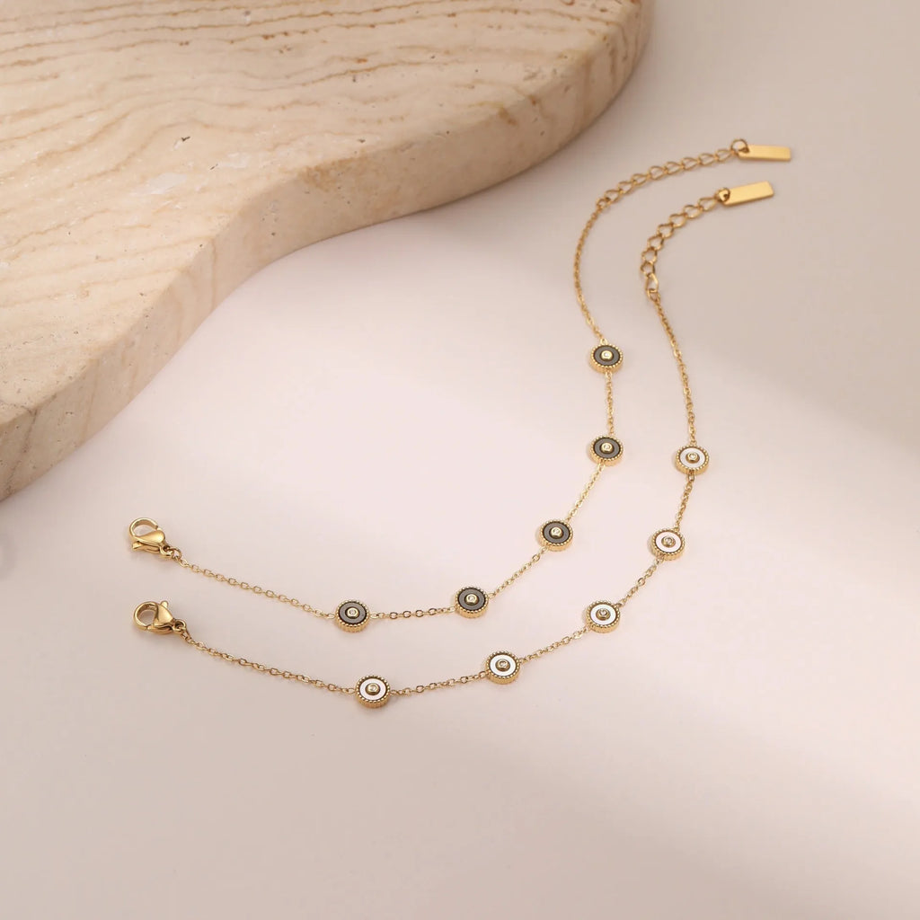Geometric fritillary pattern stainless steel bracelet with 18K gold plating and matching necklace