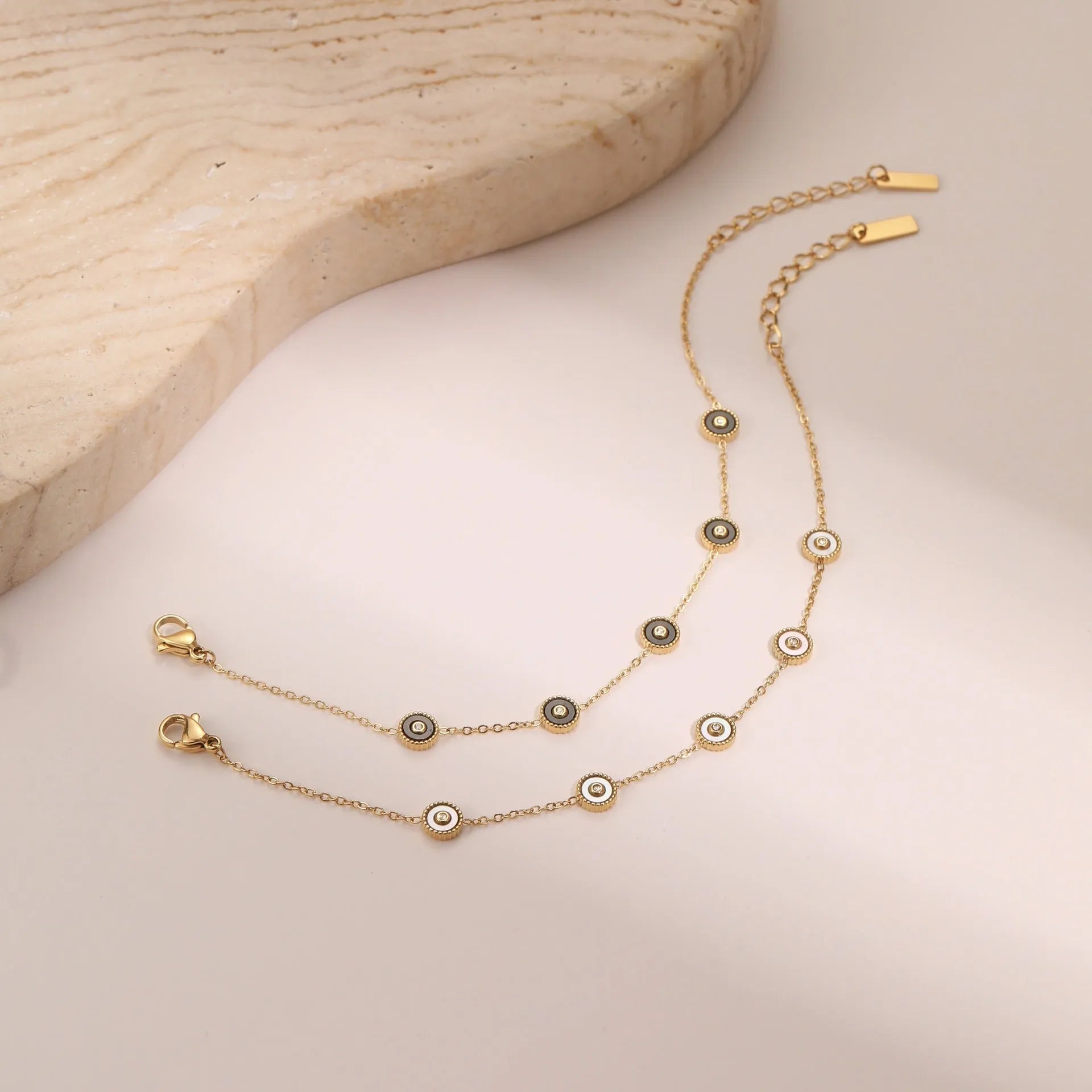Geometric fritillary pattern stainless steel bracelet with 18K gold plating and matching necklace