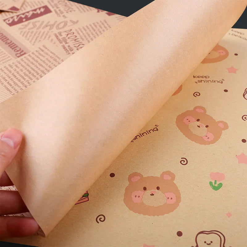 Stack of 28x38cm microwaveable food grade anti-oil Kraft baking paper sheets in English, newspaper, and retro styles