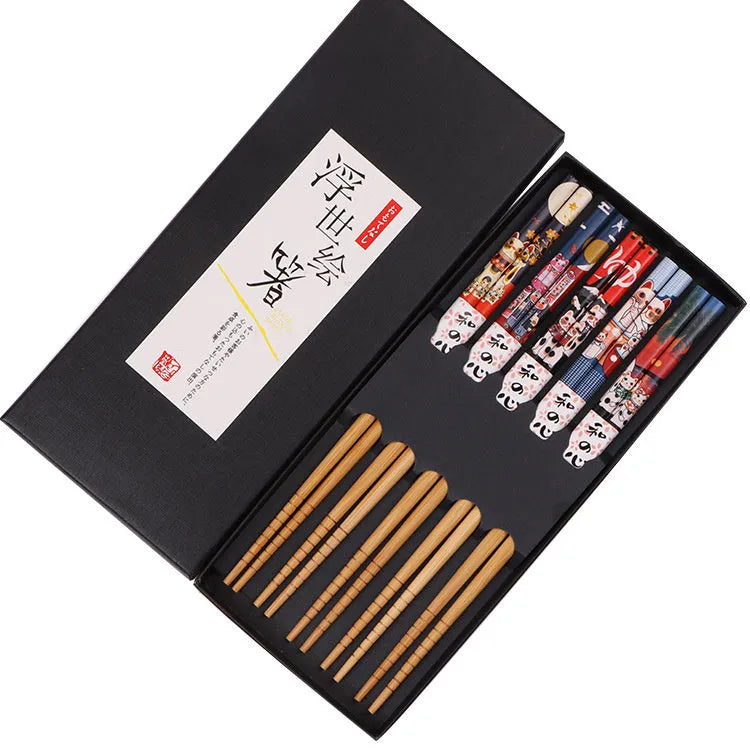 Set of bamboo chopsticks with Japanese lucky cat and elegant blue patterns in gift box or simple packaging.