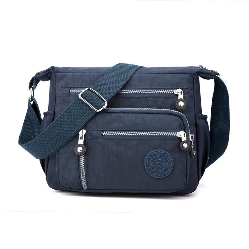 Grey nylon shoulder messenger bag with single strap and square vertical design