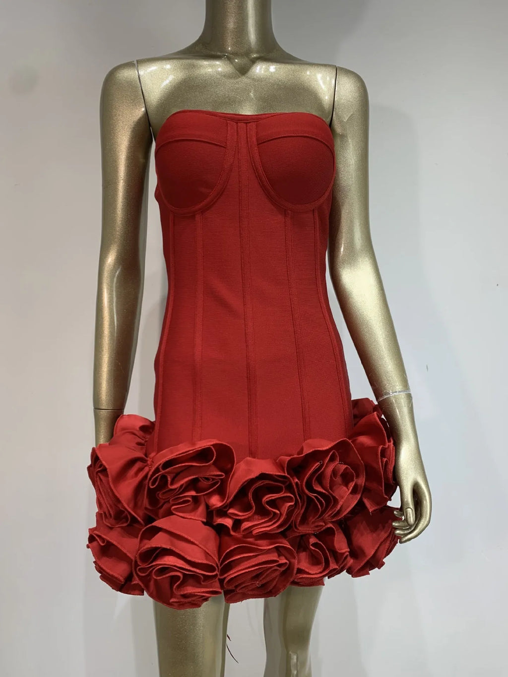 A woman wearing a solid-colour, mid-waist urban style dress available in black, red, or white.